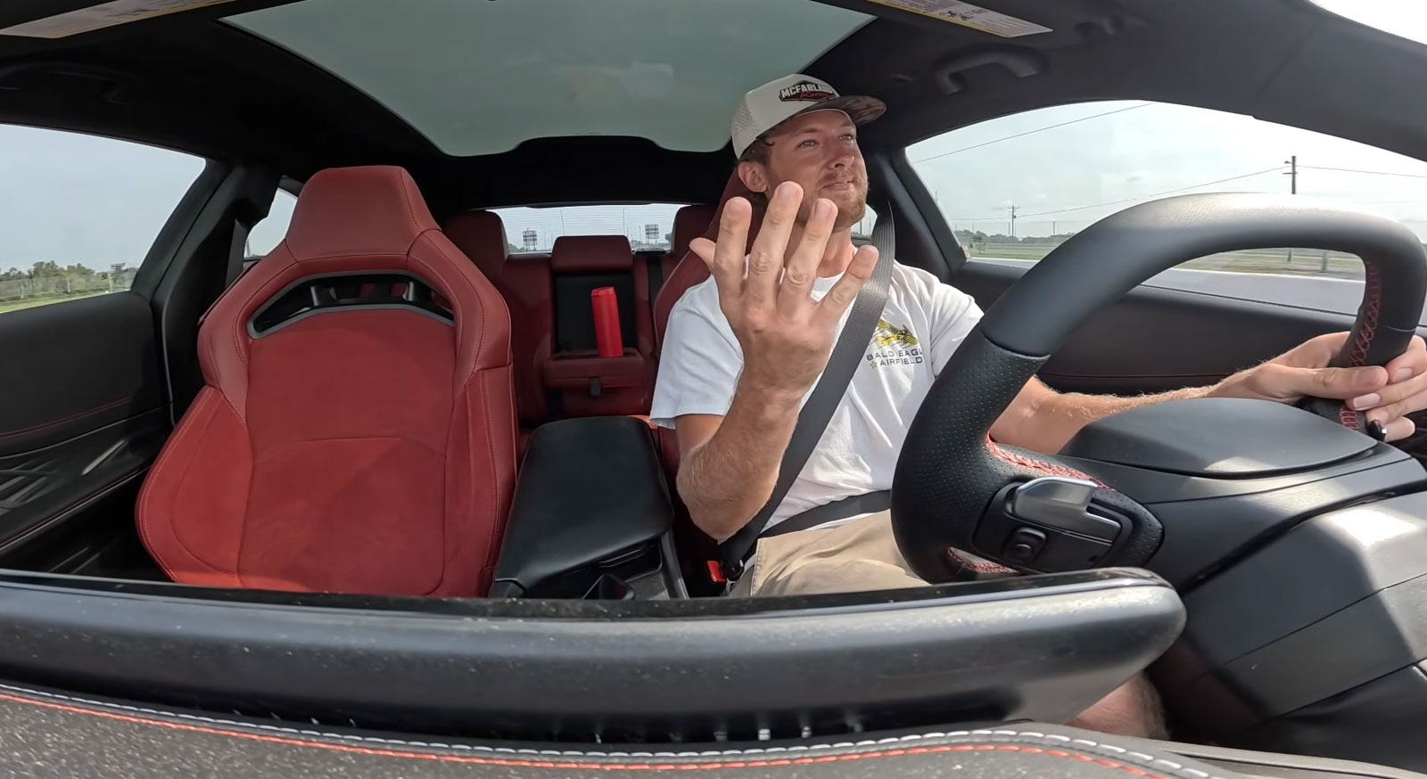 Cleetus struggles to construct a genuine smile sitting inside a 2025 Dodge Charger Daytona Scat Pack.